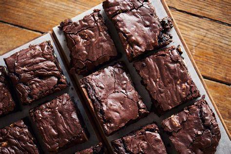 Saftige Brownies mit Baumnüssen auf Holzbrett