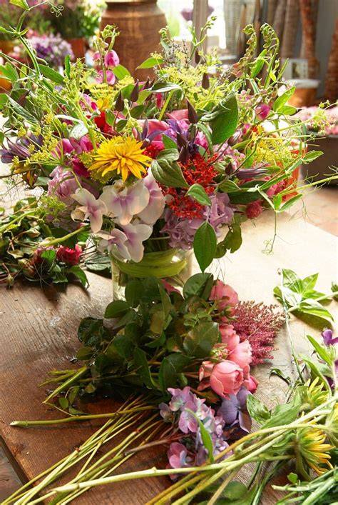 Schnittblumen in Vase auf einem Holztisch bei Tageslicht