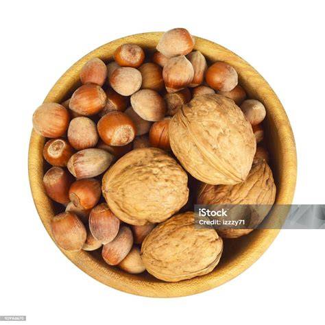 Schoko-Glasur in Schüssel, Schokotröpfchen und Walnüsse