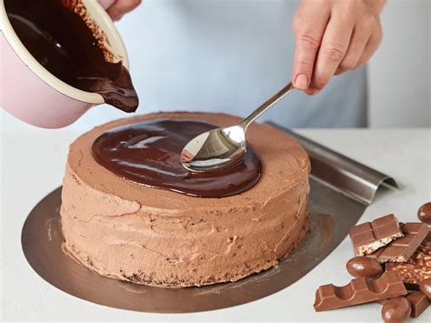 Schokoladen-Ganache wird über eine Torte gegossen