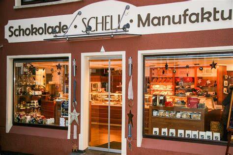 Schokoladenmanufaktur: Blick durch die Glasfront auf Chocolatiers bei der Arbeit