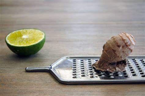 Schokoladentafel mit Ingwer und Limette auf Holztisch