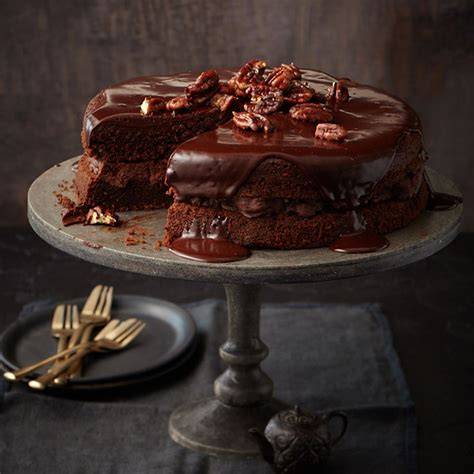 Schokoladentorte mit glänzender Lindt-Glasur, angeschnittener Tortenanschnitt mit Ganache-Füllung