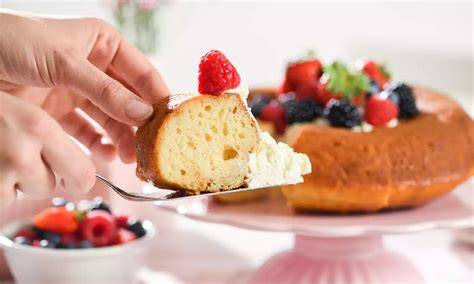 Servierte Portion Savarin mit frischen Beeren und Sahne