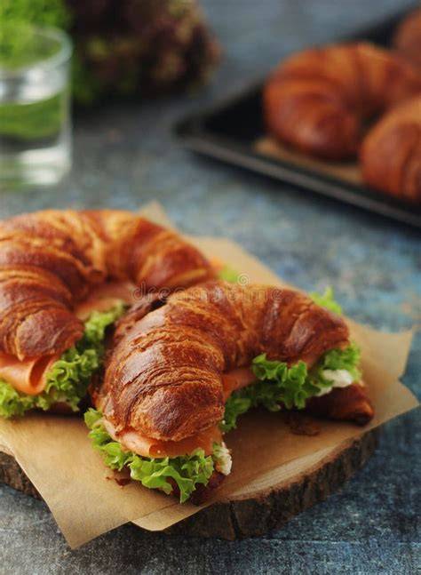 Serviervorschlag: Croissants auf Holzbrett mit Salat und Dip