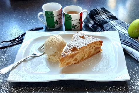 Serviervorschlag: Stück Apfel Mascarpone Kuchen auf Teller, daneben Kaffee