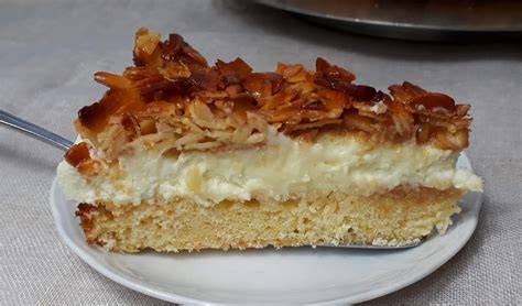 Stück Bienenstich mit Puddingfüllung auf Teller