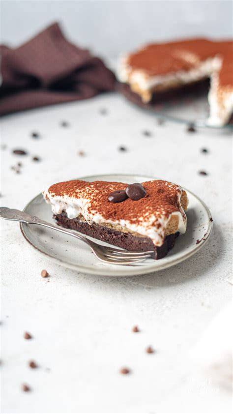Stück Mokka-Buttercreme-Torte auf einem Kuchenteller mit Kaffeetasse