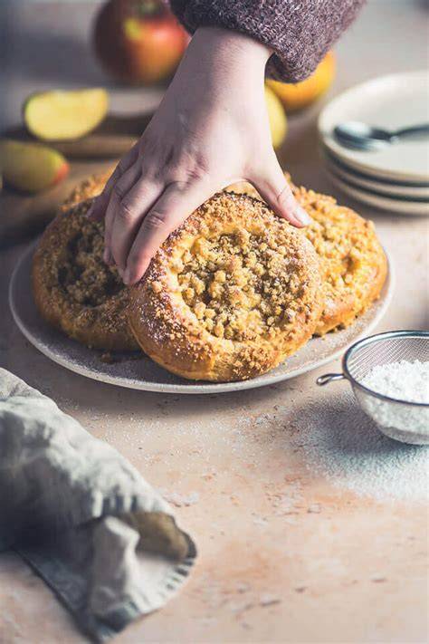 Step-by-step Illustration: Apfel vorbereiten, Streusel formen, Schmandcreme auftragen