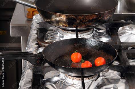 Tomaten halbiert auf Pfanne beim Anbraten