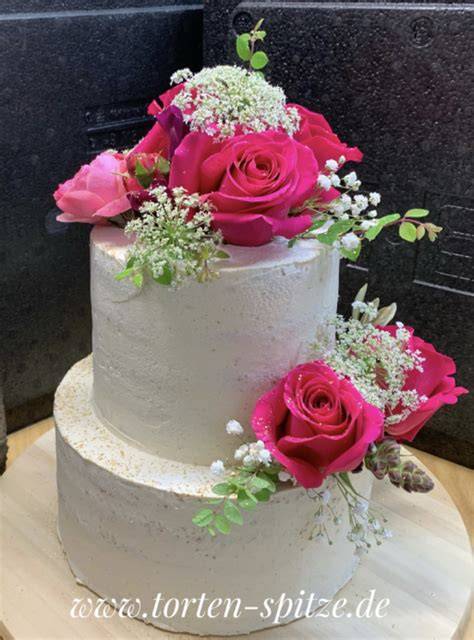 Torte, dekoriert mit Rosen aus Frosting und goldenen Zuckerperlen
