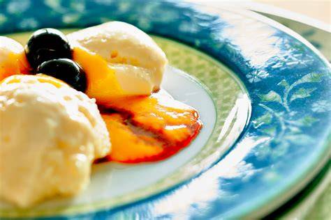Variation mit Mango- und Pfirsichstücken auf der Creme