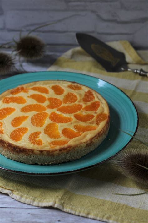 Vegane Käsekuchen-Variante mit Mandarinen auf einem Holzbrett