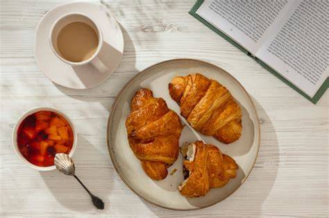 Vergleich Teller: Vollkornfrühstück vs. süßes Frühstück mit Croissant und Joghurt