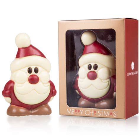 Weißer Schokoladen-Weihnachtsmann und Pralinen in Geschenkverpackung