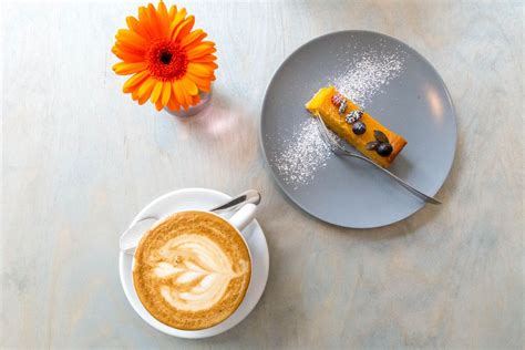 Zuckersticks auf einem Cafétisch neben einer Tasse Cappuccino