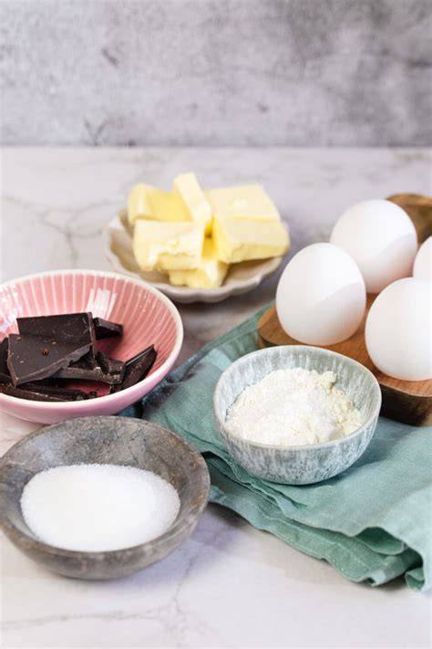 Zutatenstillleben: Buchweizenmehl, Zartbitterschokolade, Butter, Eier, brauner Zucker