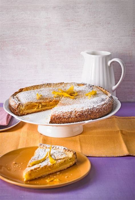 fertiger italienischer ricottakäsekuchen auf tortenplatte mit puderzucker