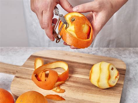 frische bio-orangen, schnittbretter, schale und filets, zesten und saft in gläsern