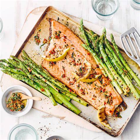 gegarter lachs mit grünem spargel und honig-senf-soße angerichtet auf teller