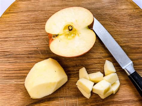 geschälte und geschnittene Äpfel mit Zimt und Zucker in Schüssel