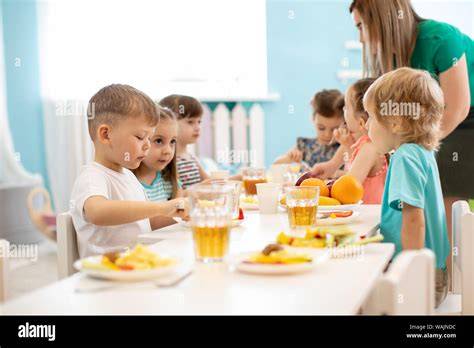 glückliche Kinder essen Karottenwaffeln am Tisch
