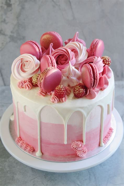 rosa torte auf kuchenplatte, ombré-frosting und rosafarbene dekoration